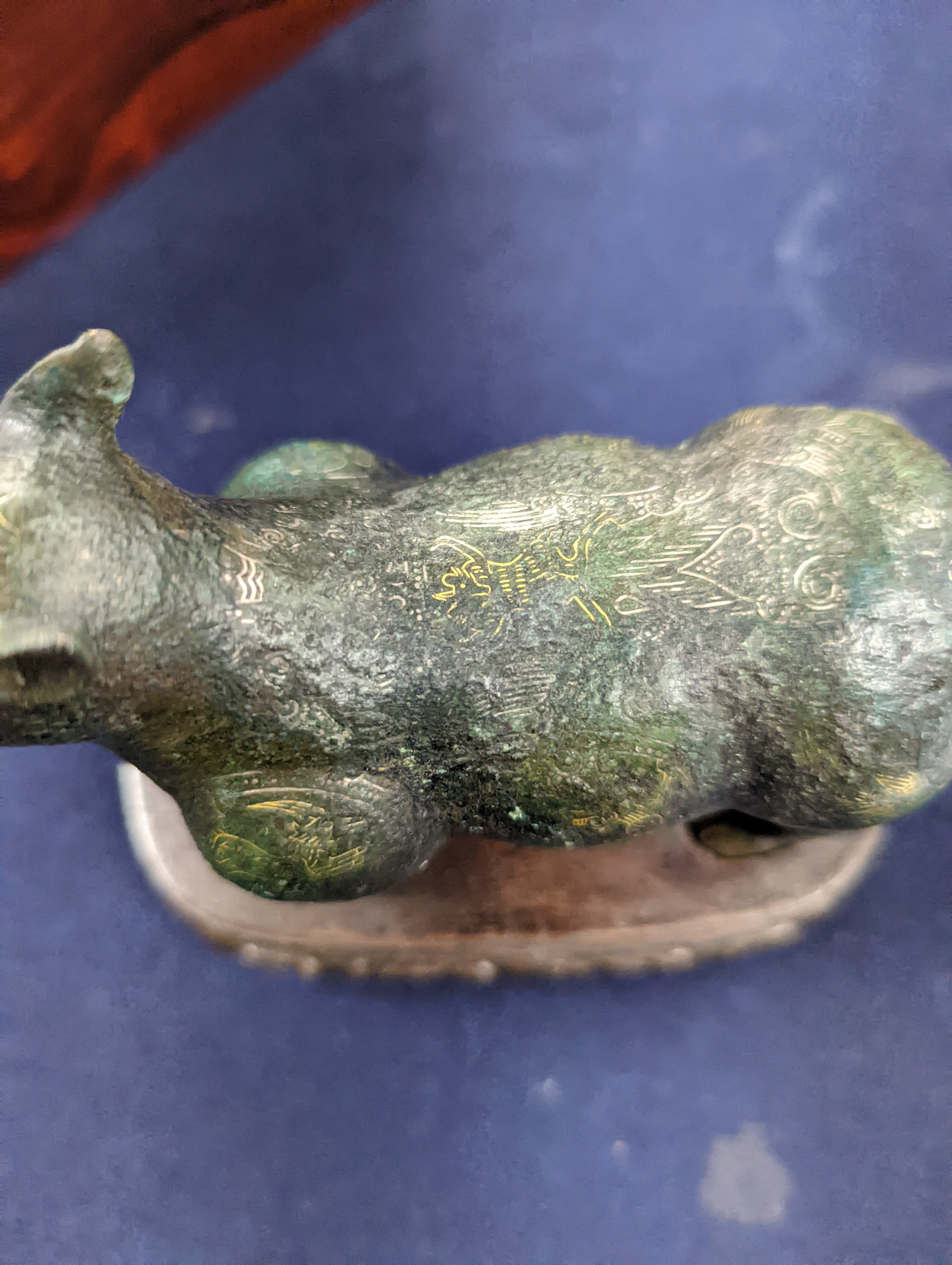 A Chinese gold and silver inlaid bronze figure of a tapir, Han dynasty or later, L. 12cm, excluding hardwood stand and fitted box